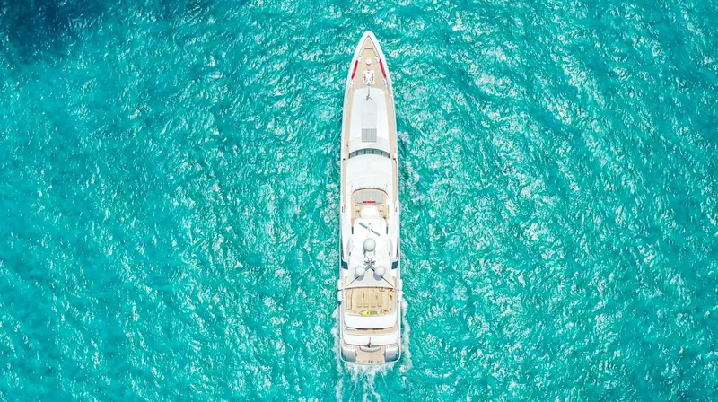 W Yacht Photos Pics Aerial view of 2013 Feadship yacht cruising in clear turquoise waters.