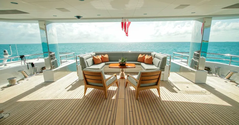 W Yacht Photos Pics Luxurious Feadship yacht deck with elegant seating, ocean view, and wooden flooring, 2013 model.