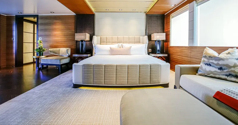 W Yacht Photos Pics Luxurious yacht bedroom interior with modern design, featuring a large bed and elegant furnishings.