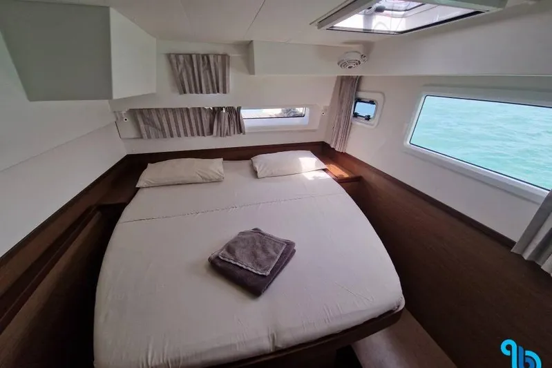 Yacht Photos Pics Cozy cabin interior of 2020 Lagoon 42 catamaran with ocean view windows.