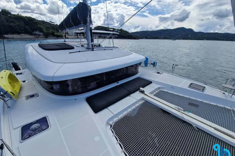  Yacht Photos Pics 2020 Lagoon 42 catamaran on calm waters, featuring spacious deck and modern design.