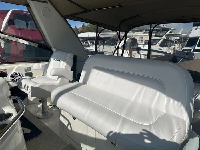 L'eternel Yacht Photos Pics 1998 Sea Ray 400 Sundancer interior with white seating and marina view.