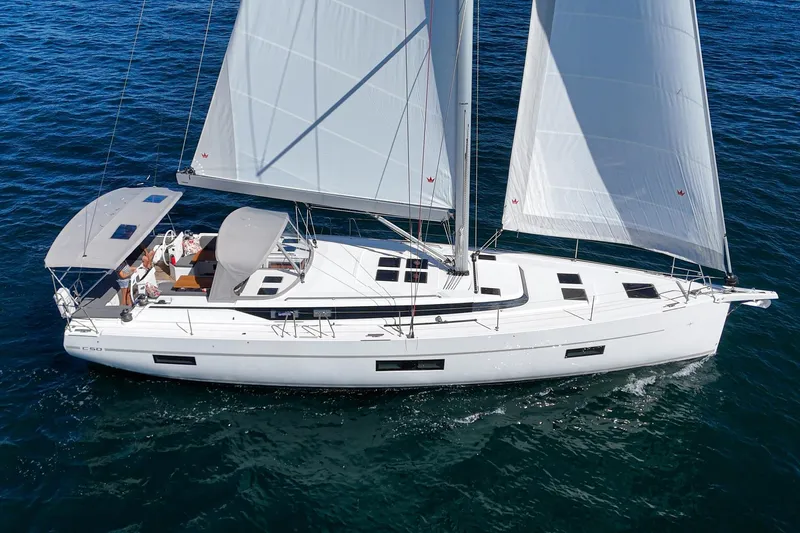Tuanis Yacht Photos Pics 2023 Bavaria C50 sailboat cruising on open water with full sails.