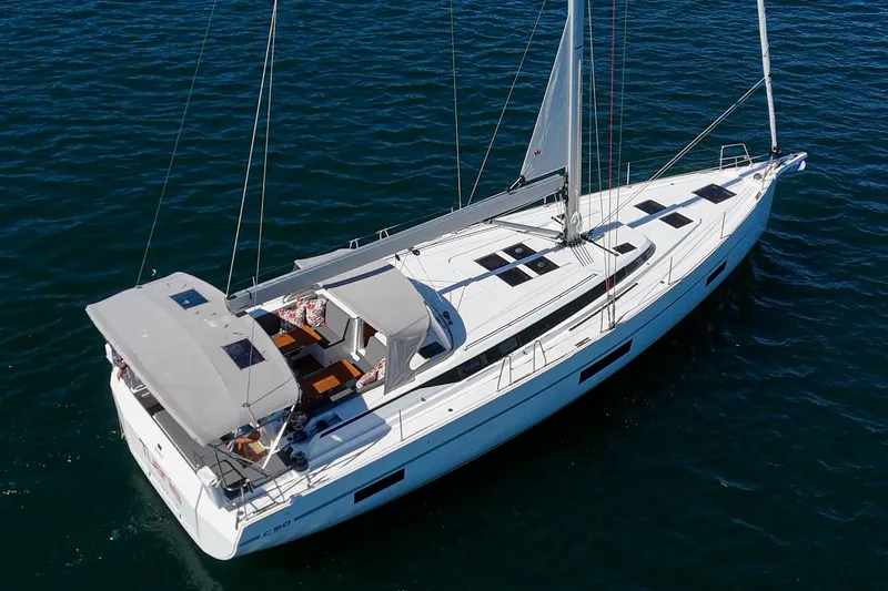 Tuanis Yacht Photos Pics 2023 Bavaria C50 yacht sailing on open water, showcasing sleek design and spacious deck.