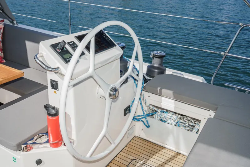 Tuanis Yacht Photos Pics Steering wheel of 2023 Bavaria C50 yacht with nautical equipment and ocean view.