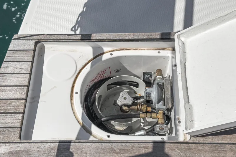 Tuanis Yacht Photos Pics Built-in gas compartment on 2023 Bavaria C50 yacht, featuring secure fittings and hoses.