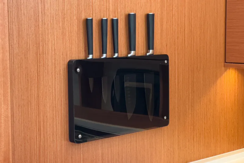 Tuanis Yacht Photos Pics Knife set on wooden wall in 2023 Bavaria C50 yacht kitchen.