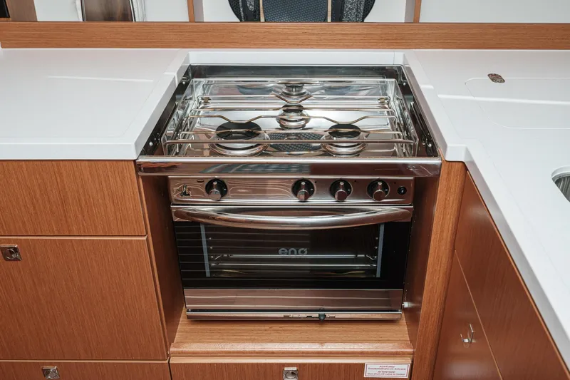 Tuanis Yacht Photos Pics Modern kitchen stove in 2023 Bavaria C50 yacht, featuring sleek design and stainless steel finish.