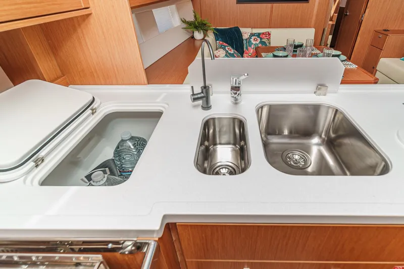 Tuanis Yacht Photos Pics Modern kitchen area in 2023 Bavaria C50 yacht with dual sinks and storage.