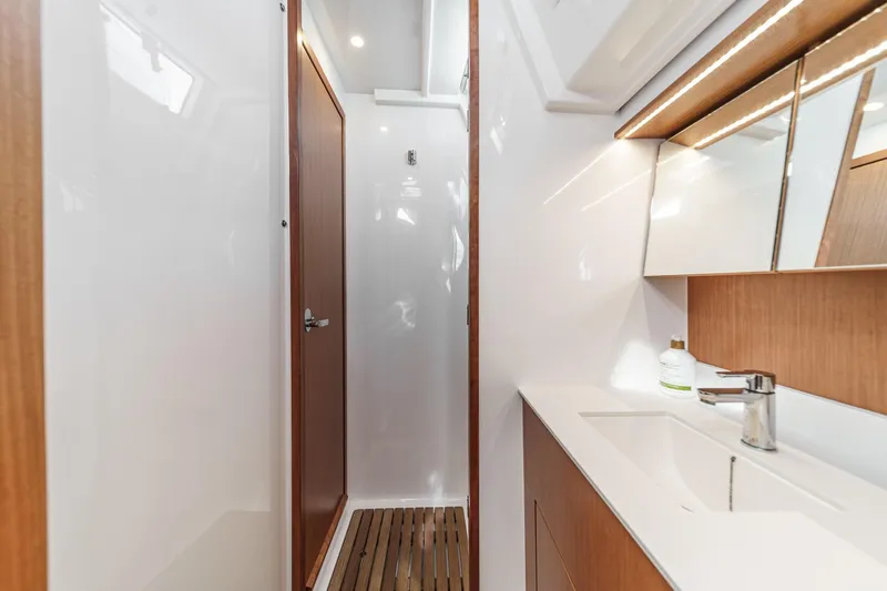 Tuanis Yacht Photos Pics Modern bathroom interior of 2023 Bavaria C50 yacht, featuring sleek design and wooden accents.