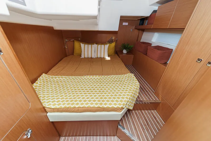 Tuanis Yacht Photos Pics Luxurious 2023 Bavaria C50 yacht cabin with cozy bedding and elegant wood finish.