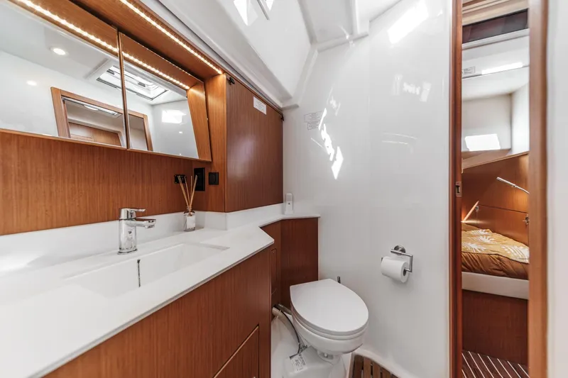 Tuanis Yacht Photos Pics Luxurious 2023 Bavaria C50 yacht bathroom with modern fixtures and wooden accents.