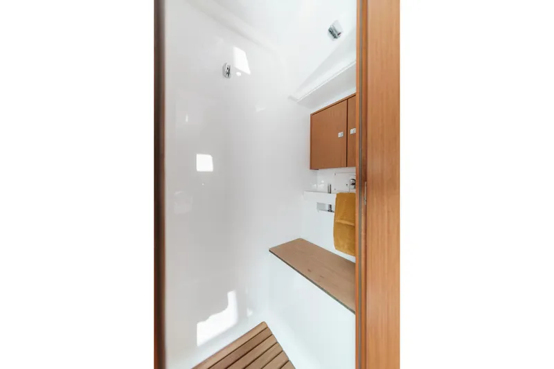 Tuanis Yacht Photos Pics 2023 Bavaria C50 yacht interior with wooden cabinetry and modern fixtures.