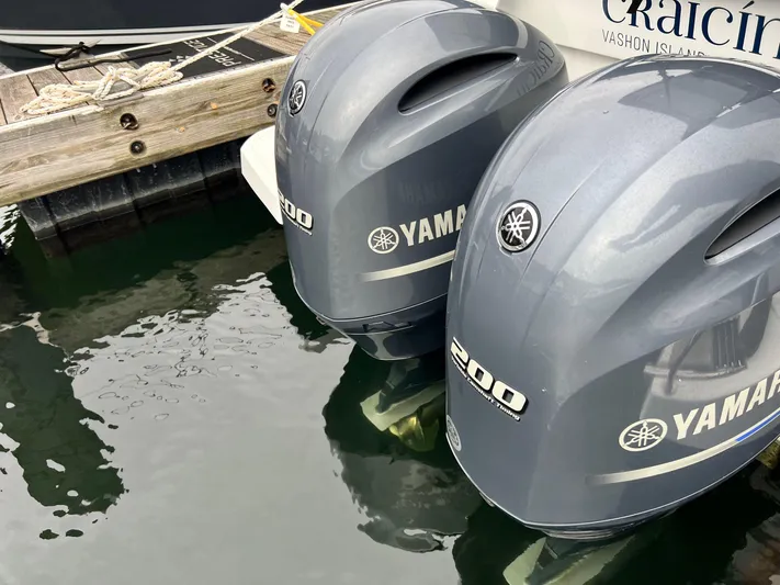  Yacht Photos Pics Twin Yamaha 200 outboard motors on a 2023 Jeanneau NC 895 boat at a dock.