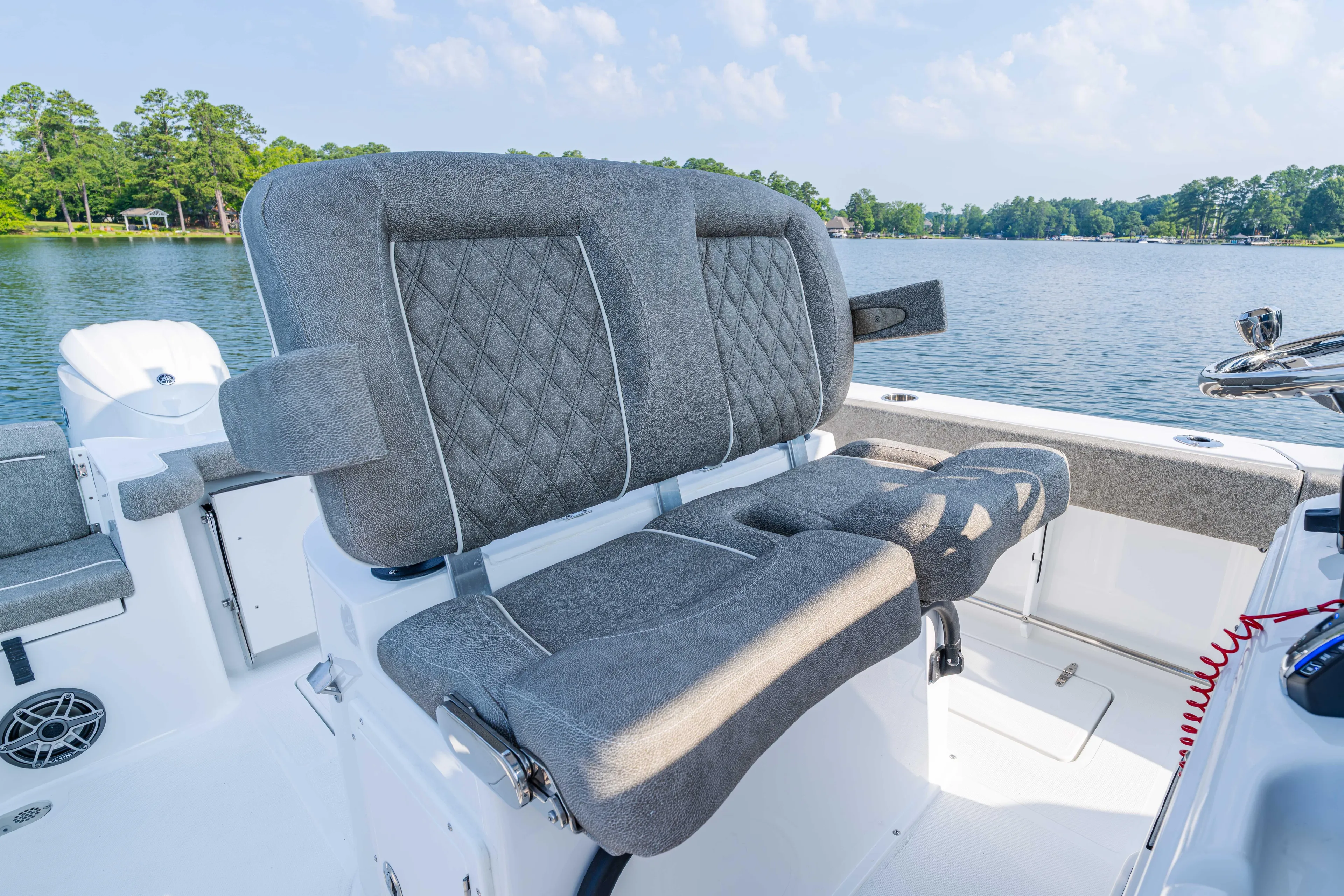  Yacht Photos Pics 2026 Sea Hunt Gamefish 25 boat interior with plush seating, on a serene lake backdrop.