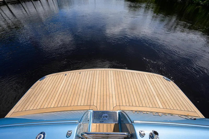 Drops Of Jupiter Yacht Photos Pics 2024 Palm Beach Motor Yachts GT50, teak deck, overlooking calm water.