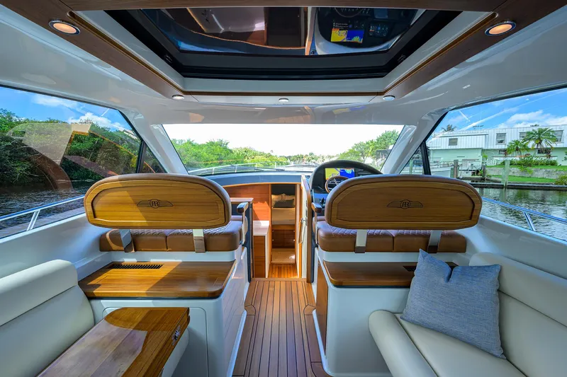 Drops Of Jupiter Yacht Photos Pics Luxurious interior of 2024 Palm Beach Motor Yachts GT50, featuring elegant wood finishes.