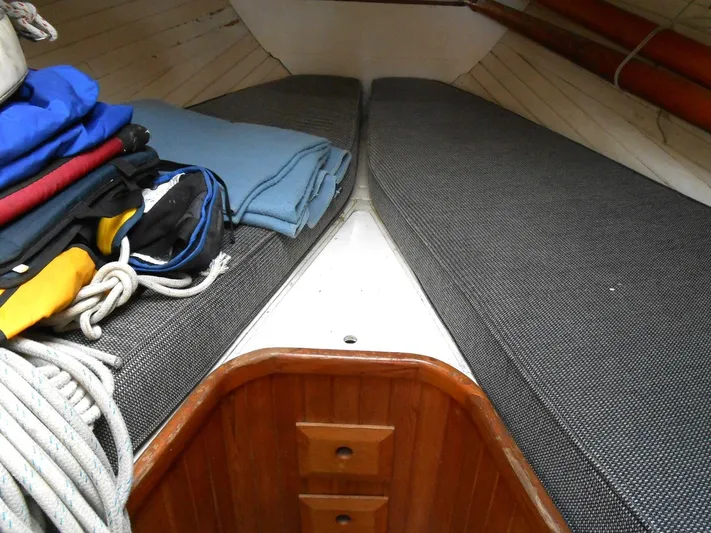 Merrywing Yacht Photos Pics Interior of 1962 Custom Merrywing boat with cushions and folded blankets.