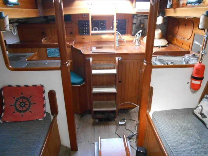 Merrywing Yacht Photos Pics Interior of a 1962 Custom Merrywing boat with wooden finishes and cozy seating.