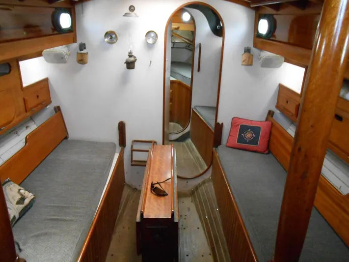 Merrywing Yacht Photos Pics Interior of a 1962 Custom Merrywing boat with wooden furnishings and twin beds.