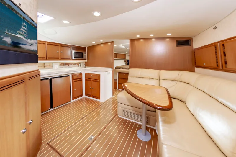 Salt Shaker Yacht Photos Pics Interior of 2008 Cabo 40 Express yacht with leather sofa and wooden cabinetry.