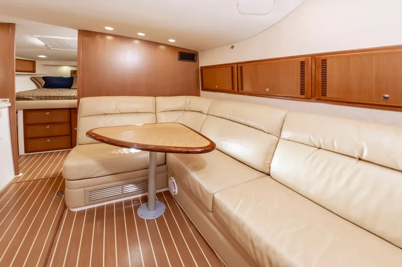 Salt Shaker Yacht Photos Pics Interior of 2008 Cabo 40 Express yacht with leather sofa and wooden table.