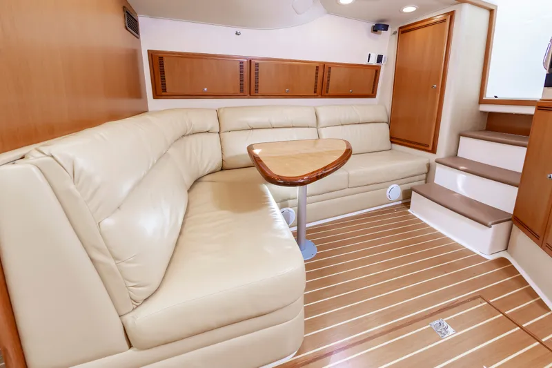 Salt Shaker Yacht Photos Pics Interior of 2008 Cabo 40 Express with leather sofa and wooden table.