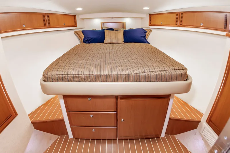 Salt Shaker Yacht Photos Pics Interior of 2008 Cabo 40 Express with bed and wooden cabinets.
