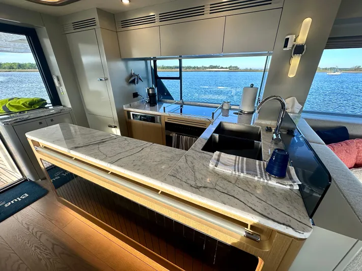  Yacht Photos Pics Luxurious 2024 Sirena 68 yacht kitchen with marble countertops and scenic ocean view.