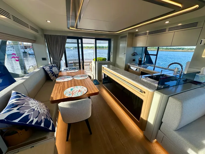  Yacht Photos Pics Luxurious interior of 2024 Sirena 68 yacht with elegant dining and kitchen area.