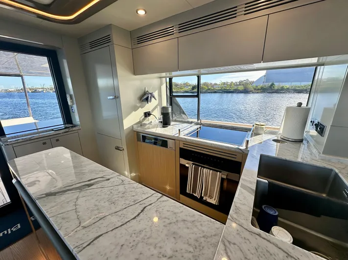  Yacht Photos Pics Luxurious kitchen interior of 2024 Sirena 68 yacht with marble countertops and scenic water view.