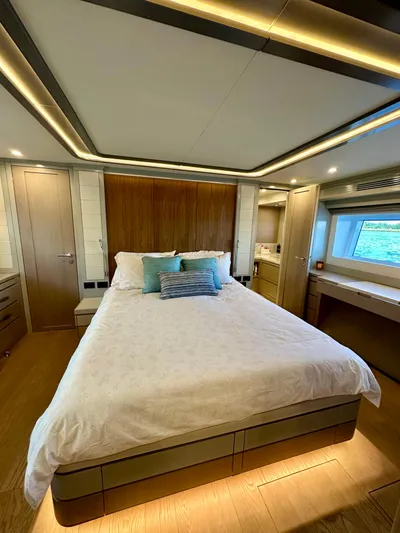  Yacht Photos Pics Luxurious bedroom interior of 2024 Sirena 68 yacht with modern design and large window view.