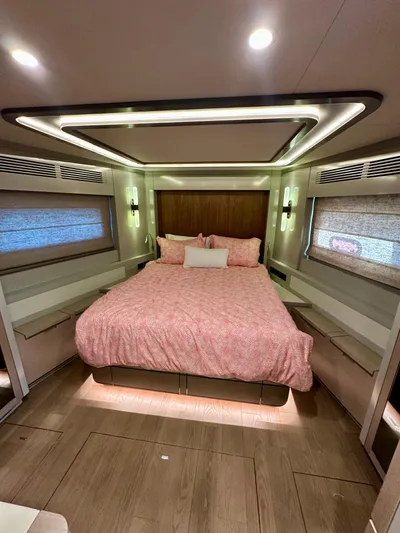  Yacht Photos Pics Luxurious 2024 Sirena 68 yacht bedroom with modern lighting and elegant decor.