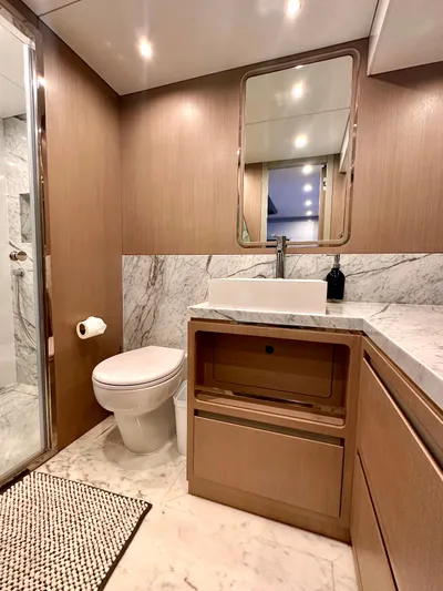  Yacht Photos Pics Luxurious bathroom in 2024 Sirena 68 yacht with marble accents and modern fixtures.