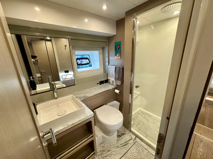  Yacht Photos Pics Luxurious bathroom in 2024 Sirena 68 yacht, featuring modern fixtures and elegant marble accents.