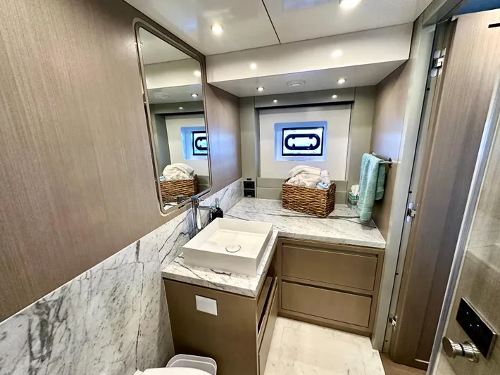  Yacht Photos Pics Luxurious bathroom in 2024 Sirena 68 yacht with marble countertop and modern fixtures.