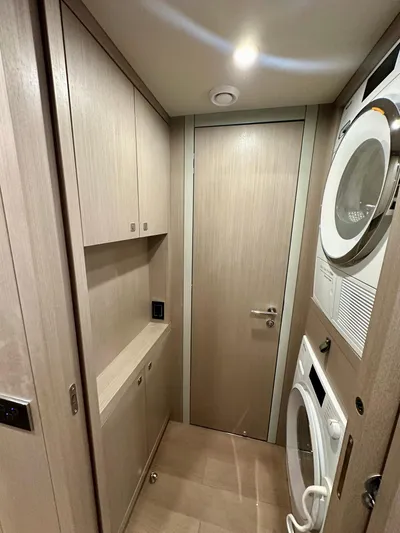  Yacht Photos Pics Laundry room in 2024 Sirena 68 yacht with stacked washer and dryer.