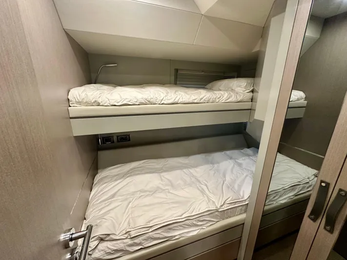  Yacht Photos Pics Bunk beds in the 2024 Sirena 68 yacht cabin, featuring modern design and cozy bedding.