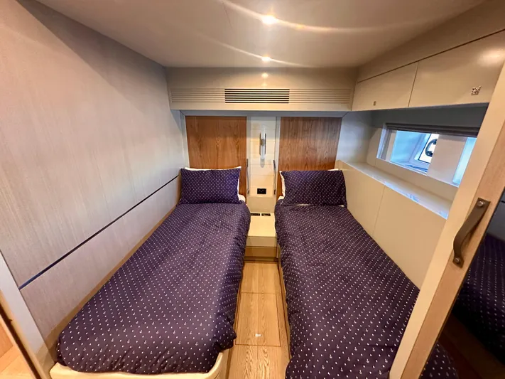  Yacht Photos Pics Twin cabin interior of 2024 Sirena 68 yacht with modern design and cozy bedding.