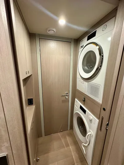  Yacht Photos Pics Laundry area in 2024 Sirena 68 yacht with stacked washer and dryer.