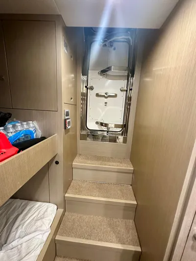  Yacht Photos Pics Interior stairs of 2024 Sirena 68 yacht with modern design and storage.