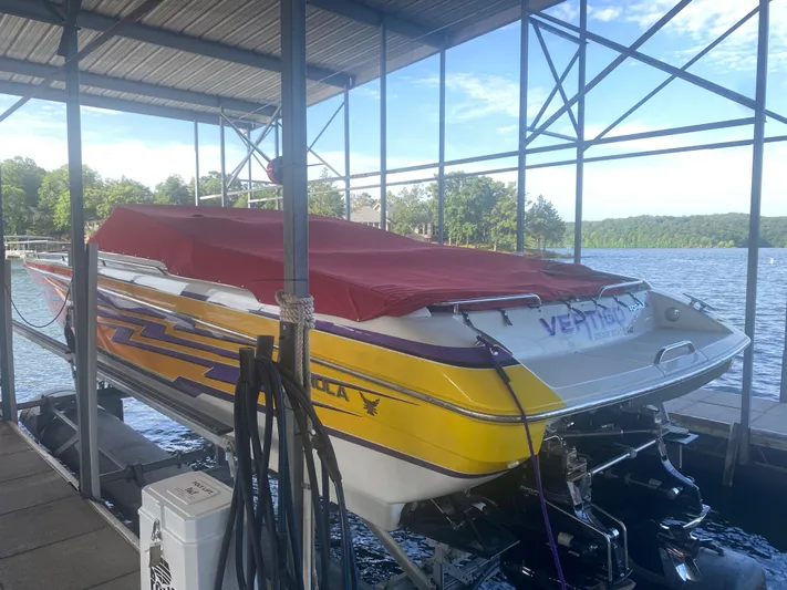  Yacht Photos Pics 2006 Formula 353 FASTech boat docked, covered with a red tarp, vibrant yellow and purple design.
