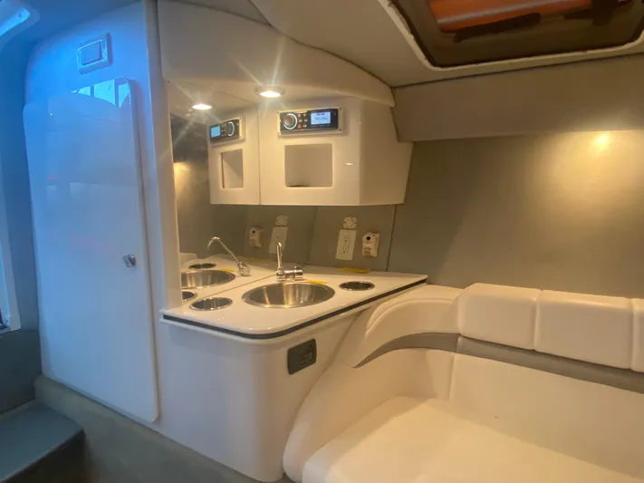  Yacht Photos Pics 2006 Formula 353 FASTech cabin interior with kitchenette and seating area.