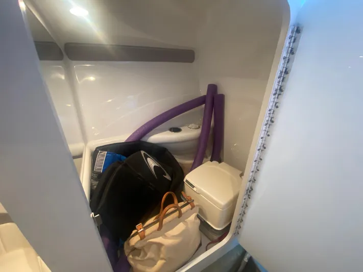  Yacht Photos Pics Interior of 2006 Formula 353 FASTech boat with storage items and portable toilet.