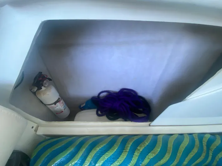  Yacht Photos Pics Storage compartment in 2006 Formula 353 FASTech with fire extinguisher and rope.