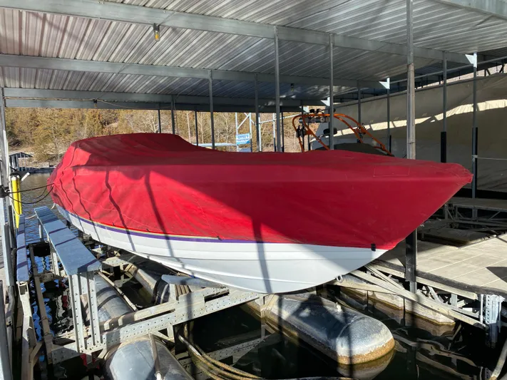  Yacht Photos Pics 2006 Formula 353 FASTech boat with red cover on a lift in a marina.