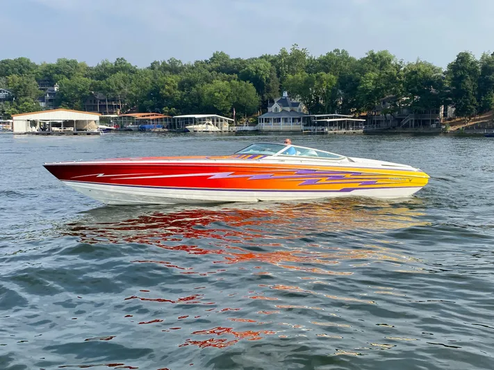  Yacht Photos Pics 2006 Formula 353 FASTech speedboat with vibrant red and yellow design on a lake.