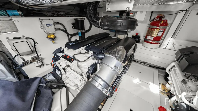  Yacht Photos Pics Engine room of 2019 Princess F49 yacht with visible machinery and fire extinguisher.