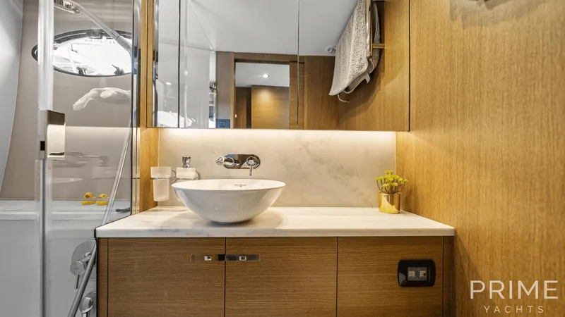  Yacht Photos Pics Luxurious bathroom on 2019 Princess F49 yacht with modern sink and elegant wood finish.
