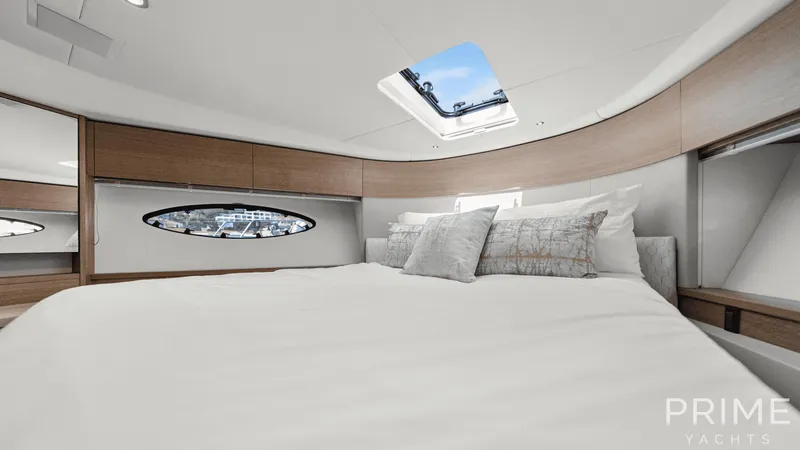  Yacht Photos Pics Luxurious bedroom interior of 2019 Princess F49 yacht with skylight and elegant decor.